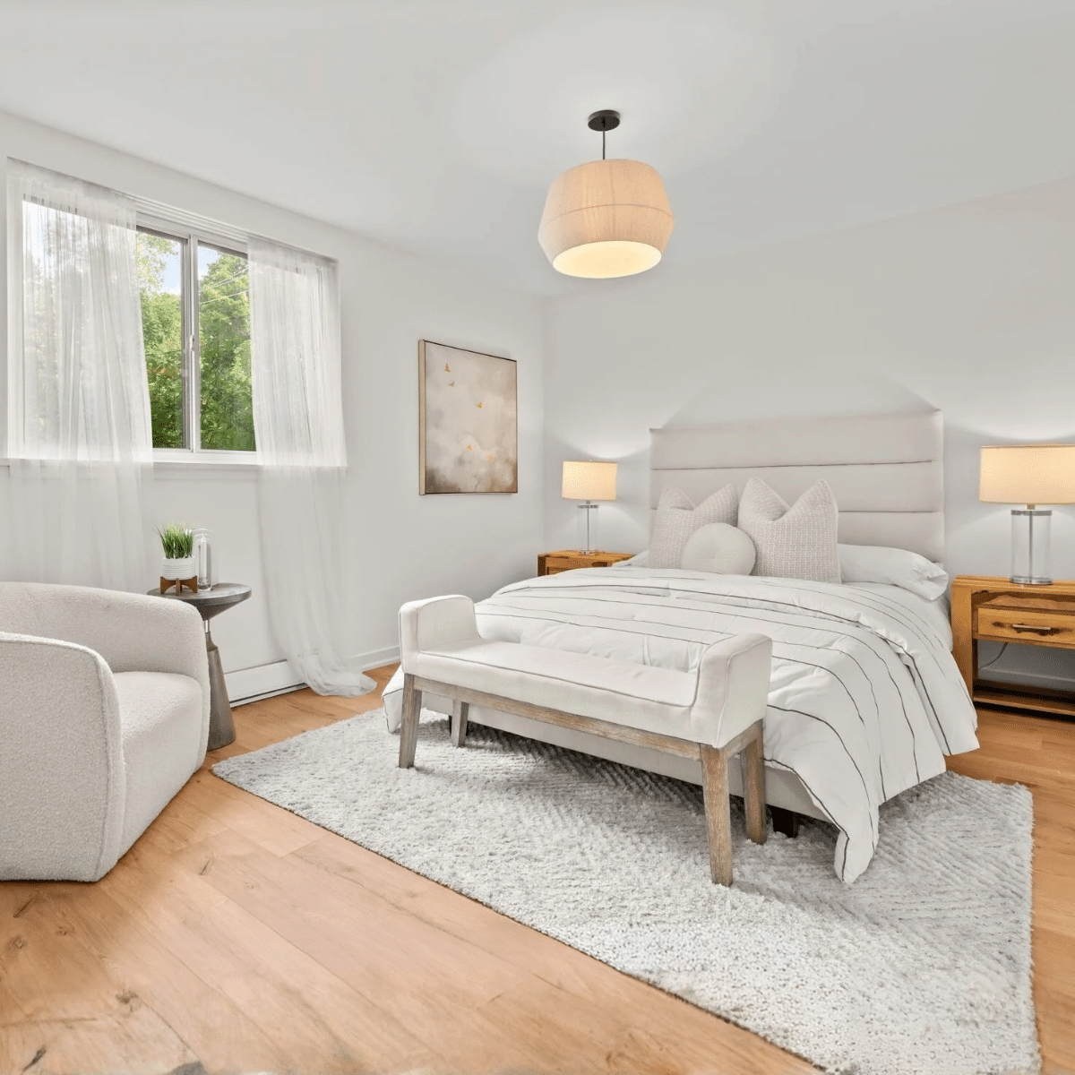 Beaches condo co-op bedroom staged with queen bed and bench