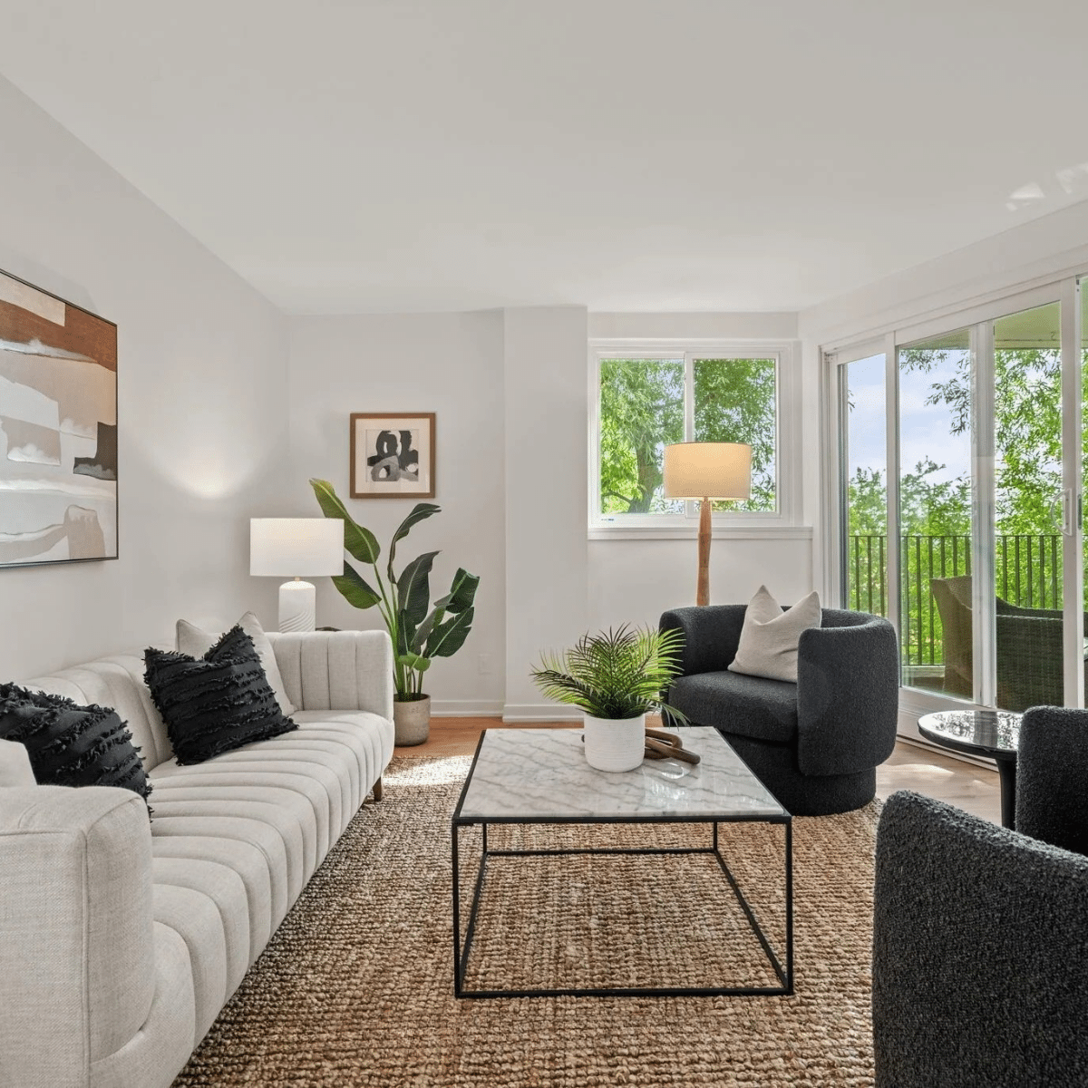 Beaches condo co-op living room staged with furniture, rug and art
