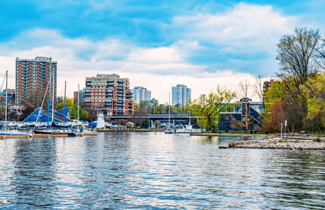 HaltonAlt Bronte Village harbour with waterfront condominiums and sailboats representing Lux Furniture Rentals' Halton Region delivery service area.