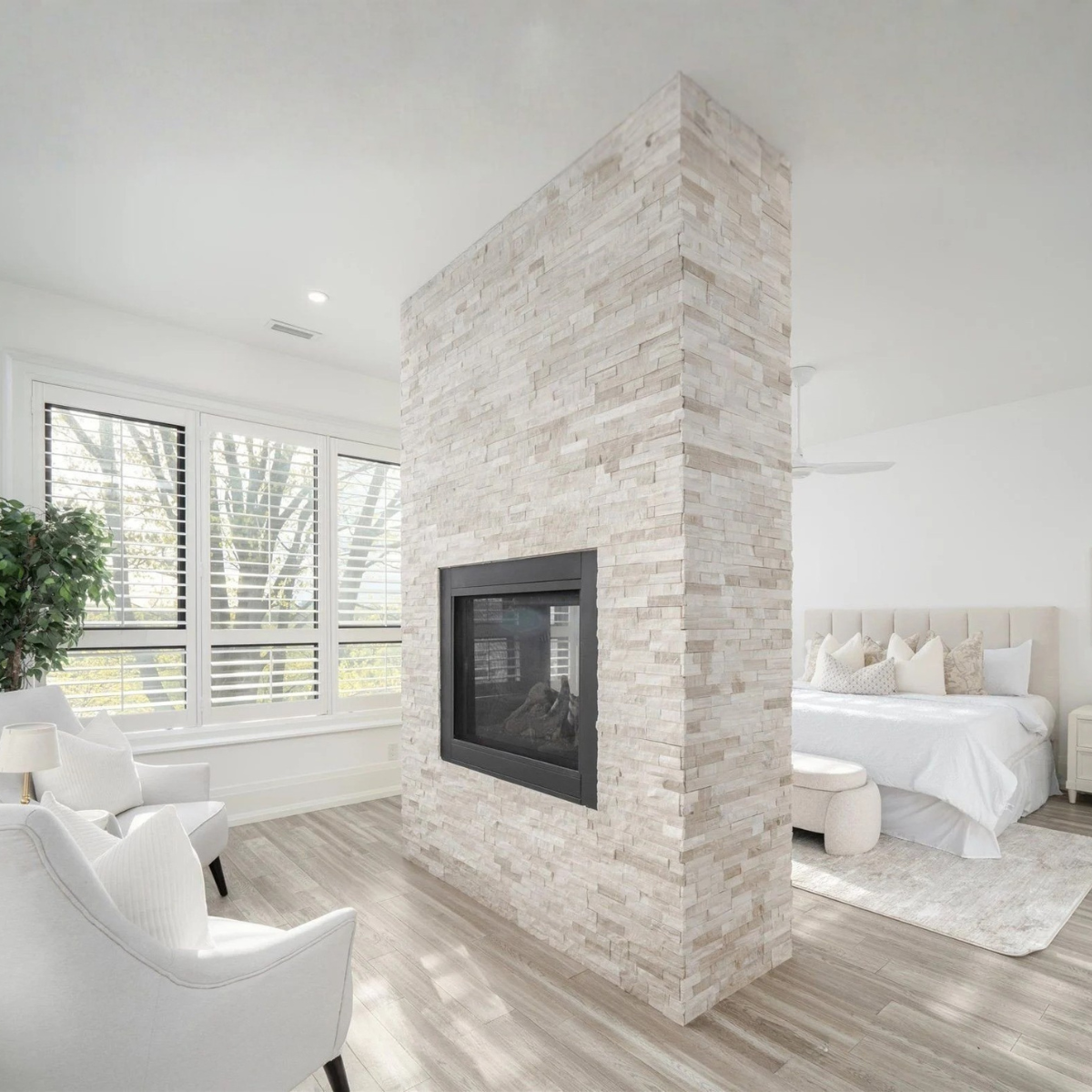 Rouge River waterfront bedroom staged with king bed and accent chairs