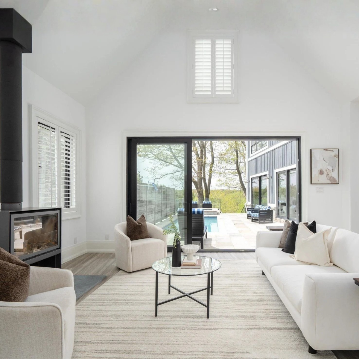 Rouge River waterfront living room staged with sofa and accent chairs