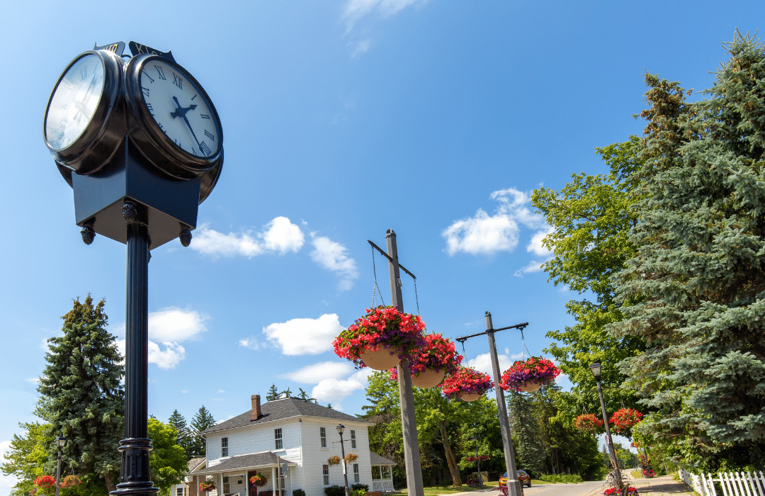 YorkLight Historic York Region main street with a cast-iron clock and hanging flower baskets representing Lux Furniture Rentals' York Region delivery service area.