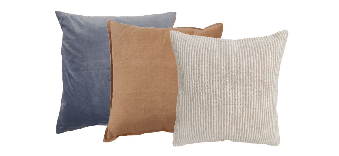 Set of three throw pillows in blue, camel and ivory textured fabrics