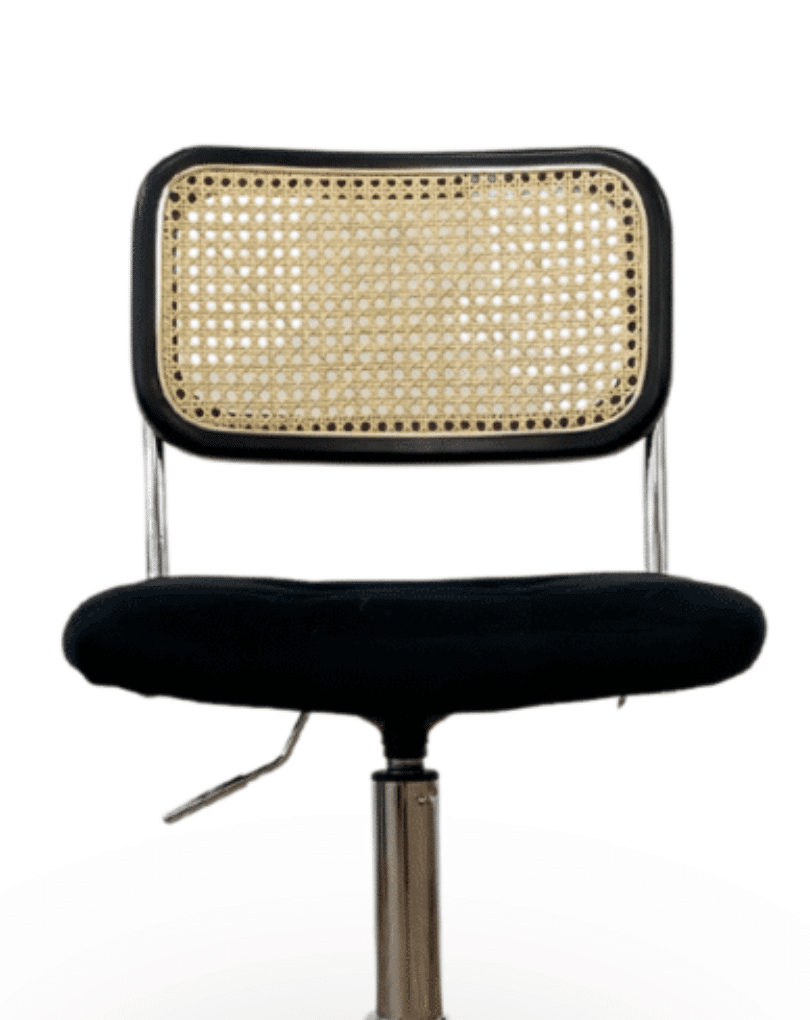 Black upholstered office chair with a natural cane back, chrome frame and adjustable pedestal base
