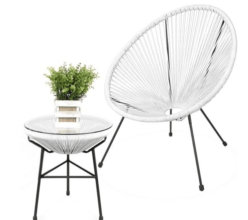 Black outdoor dining table with matching slatted chairs and tableware